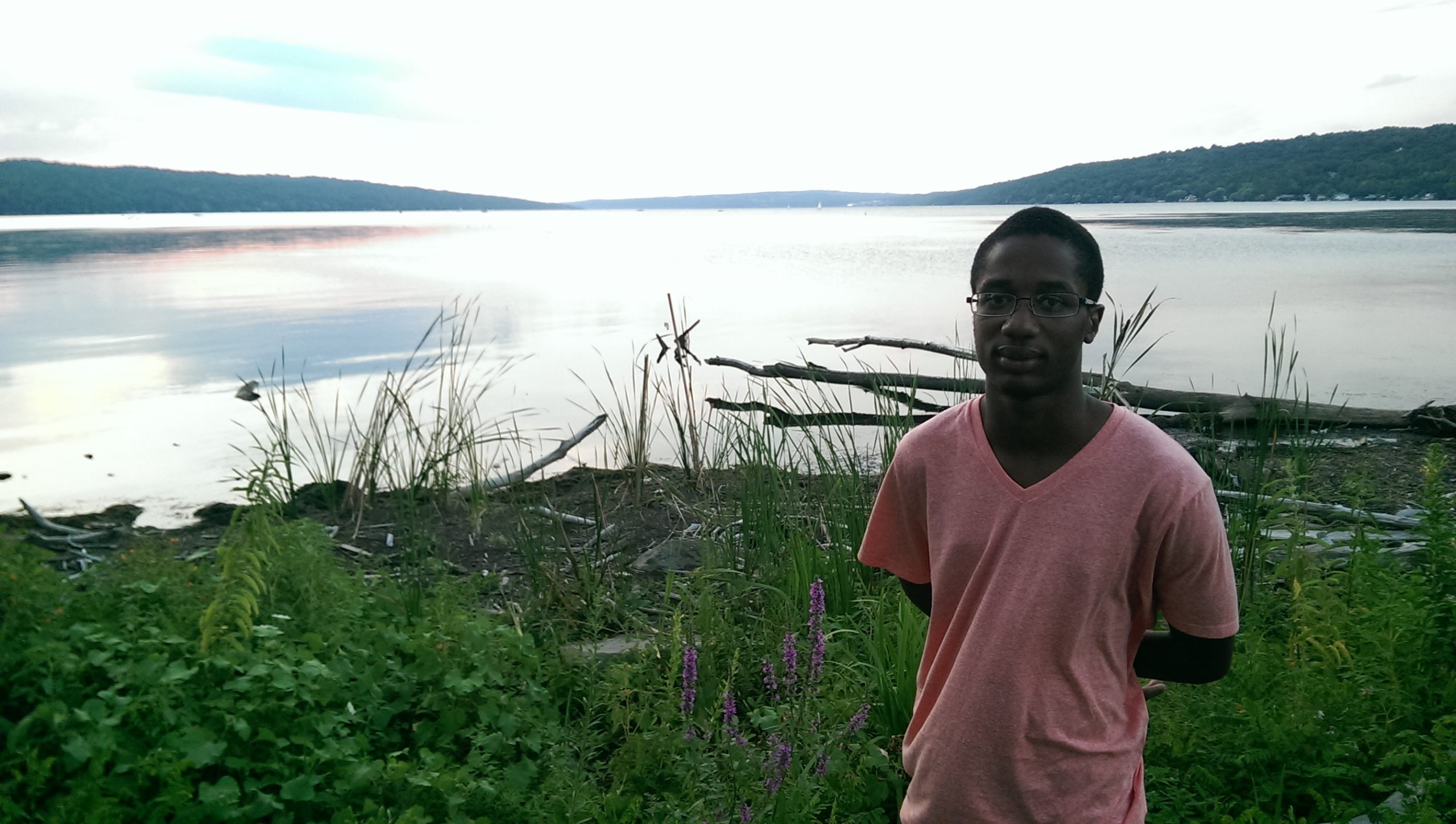 young man standing in the cayuga wetlands